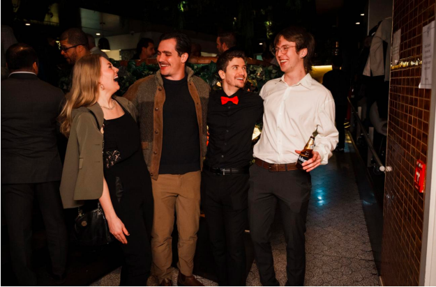 Tech In A Tux founder Alejandro Calle celebrating with colleagues and community members